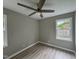 Cozy bedroom with light gray walls, wood-look flooring, and a modern ceiling fan at 1064 Abbott Rd, Henderson, NC 27537