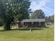 Charming single-story brick home with a well-maintained lawn and mature trees at 1064 Abbott Rd, Henderson, NC 27537