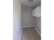 Efficient laundry room space with overhead storage and durable laminate flooring at 1064 Abbott Rd, Henderson, NC 27537