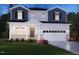 Charming two-story home with a two-car garage, beautiful landscaping, and a welcoming front porch at 1124 Landen Creek Ln, Zebulon, NC 27597
