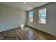 Well-lit bedroom with vinyl floors and windows showcasing the home's exterior at 116 Legolas Ct, Middlesex, NC 27557