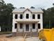 Under construction two-story home exterior featuring brick base and builder's wrap at 116 Legolas Ct, Middlesex, NC 27557