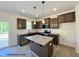 Modern kitchen features granite countertops, stainless appliances, and a functional island at 116 Legolas Ct, Middlesex, NC 27557