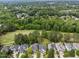 Beautiful aerial view of a neighborhood home near a lush green golf course surrounded by mature trees at 12217 Beestone Ln, Raleigh, NC 27614