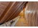 Unfinished attic space with exposed beams and insulation, offering potential for storage or conversion at 12217 Beestone Ln, Raleigh, NC 27614