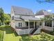Backyard featuring a deck, porch, and staircase to the lawn at 12217 Beestone Ln, Raleigh, NC 27614