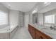 Bathroom featuring a double vanity with granite countertops, a jacuzzi tub, and a glass enclosed shower at 12217 Beestone Ln, Raleigh, NC 27614