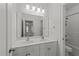 Bathroom with a double sink vanity, large mirror, and toilet at 12217 Beestone Ln, Raleigh, NC 27614