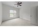 Neutral bedroom featuring carpeted floors, a ceiling fan, and a window at 12217 Beestone Ln, Raleigh, NC 27614