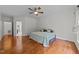 A bright bedroom featuring wood floors, a ceiling fan, and neutral walls at 12217 Beestone Ln, Raleigh, NC 27614