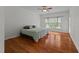 Light-filled bedroom with hardwood floors, a ceiling fan, and large windows offering ample natural light at 12217 Beestone Ln, Raleigh, NC 27614