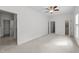 Spacious bedroom with neutral carpet and multiple entry doors at 12217 Beestone Ln, Raleigh, NC 27614