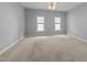 Expansive bedroom with neutral carpet and two large windows at 12217 Beestone Ln, Raleigh, NC 27614