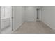 Empty bedroom featuring carpeted floors, a small sink, and a nearby bathroom at 12217 Beestone Ln, Raleigh, NC 27614