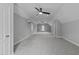 Spacious bonus room with a carpeted floor, multiple ceiling fans, and plenty of natural light through the window at 12217 Beestone Ln, Raleigh, NC 27614