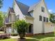 Charming two-story home showcasing meticulous landscaping, a stone detailed garage, and classic curb appeal at 12217 Beestone Ln, Raleigh, NC 27614