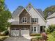 Beautiful home featuring a stone and siding exterior with an attached two-car garage and manicured landscaping at 12217 Beestone Ln, Raleigh, NC 27614