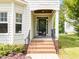 Inviting front door with brick steps and black iron railings to compliment the well-maintained landscaping at 12217 Beestone Ln, Raleigh, NC 27614