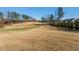 Picturesque golf course view showcasing manicured greens and a serene lakeside setting at 12217 Beestone Ln, Raleigh, NC 27614