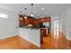 Open kitchen with granite counters, stainless appliances, breakfast bar and view to the adjacent room at 12217 Beestone Ln, Raleigh, NC 27614
