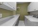 Functional laundry room with a countertop, storage cabinets, and a washer and dryer at 12217 Beestone Ln, Raleigh, NC 27614