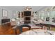 Bright living room features a stone fireplace, a ceiling fan, hardwood floors and built-in shelving at 12217 Beestone Ln, Raleigh, NC 27614