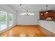 Bright living space featuring hardwood floors, French doors, and view to the kitchen at 12217 Beestone Ln, Raleigh, NC 27614