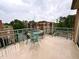 Open-air balcony with seating, offering a relaxing outdoor space with views of the surrounding buildings at 1230 Capability Dr # 106, Raleigh, NC 27606