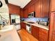 Gourmet kitchen featuring stainless steel appliances and beautiful wood cabinetry at 1230 Capability Dr # 106, Raleigh, NC 27606