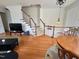 Spacious living area with hardwood floors, staircase, and access to multiple rooms at 1230 Capability Dr # 106, Raleigh, NC 27606