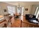 Cozy living room featuring hardwood floors, large windows, and a chandelier at 1230 Capability Dr # 106, Raleigh, NC 27606