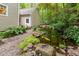 Backyard with a peaceful koi pond surrounded by lush plants and rock features at 12709 Timberlane Ct, Raleigh, NC 27613