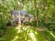 Aerial view of the home's backyard with fire pit and playground at 12709 Timberlane Ct, Raleigh, NC 27613
