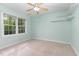 Airy bedroom with built-in shelves, large windows and soft, neutral carpeting at 12709 Timberlane Ct, Raleigh, NC 27613