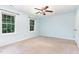 Bright bedroom featuring light blue walls, two large windows, and a classic ceiling fan at 12709 Timberlane Ct, Raleigh, NC 27613