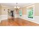 Spacious dining room featuring hardwood floors, a chandelier, and abundant natural light at 12709 Timberlane Ct, Raleigh, NC 27613