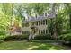 Classic two-story home with a welcoming entrance, black shutters, and beautiful landscaping at 12709 Timberlane Ct, Raleigh, NC 27613