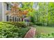 Two-story home with a brick walkway, lush landscaping and mature trees, offering a serene setting at 12709 Timberlane Ct, Raleigh, NC 27613