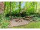 A charming fire pit area with stone seating, perfect for outdoor gatherings at 12709 Timberlane Ct, Raleigh, NC 27613