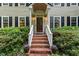 Inviting front entrance with brick steps, a decorative door, surrounded by plants and black shutters at 12709 Timberlane Ct, Raleigh, NC 27613