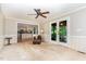 Cozy living room featuring a ceiling fan, leather chair and access to outdoor screened in porch at 12709 Timberlane Ct, Raleigh, NC 27613