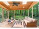 Relaxing screened porch featuring wood ceiling, skylights, comfortable seating, and serene backyard views at 12709 Timberlane Ct, Raleigh, NC 27613