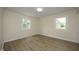 A well-lit bedroom with neutral walls, hardwood floors, and bright windows at 1422 Duggins Dr, Burlington, NC 27217