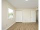 A light-filled bedroom with laminate flooring and double door closet at 1422 Duggins Dr, Burlington, NC 27217