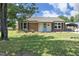 Charming brick home with a well-maintained lawn and a light blue front door, perfect for a cozy feel at 1422 Duggins Dr, Burlington, NC 27217