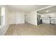 Open-concept living area with modern laminate flooring, flowing seamlessly into a bright and stylish kitchen at 1422 Duggins Dr, Burlington, NC 27217