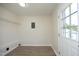 Bright mud room featuring wood-look flooring, white walls, a wire shelf, and an exterior door at 1422 Duggins Dr, Burlington, NC 27217