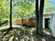 Backyard view of a brick home featuring a patio and mature trees at 1713 S Garnett St, Henderson, NC 27536