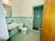 Vintage bathroom showcasing green tile, a shower, and classic fixtures at 1713 S Garnett St, Henderson, NC 27536