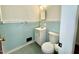 Bathroom features a vanity with sink, toilet, and blue tiling at 1713 S Garnett St, Henderson, NC 27536
